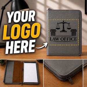 May include: Gray leather portfolio with a zipper closure, featuring a black "Law Office" logo with scales of justice and columns. The portfolio is shown open with a notepad inside. A professional accessory.