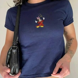 May include: A handmade wooden sign with the word "Welcome" in a whimsical font. It has a distressed white background and a dark brown border, suitable for a front door or hallway.