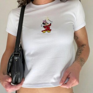 May include: A distressed wooden sign, inscribed with 'Welcome to our home' in white lettering. The sign has a rustic finish, ideal for a porch or hallway, creating a welcoming atmosphere.