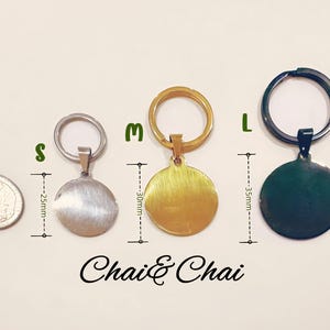 May include: Three round metal keyrings in silver, gold, and dark green, with attached key rings. The keyrings are labelled S, M, and L, with measurements of 2.5cm, 3cm, and 3.5cm. The text "Chai & Chai" is at the bottom.