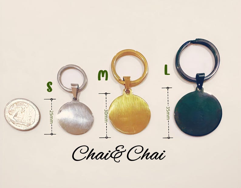 May include: Three round metal keyrings in silver, gold, and dark green, with attached key rings. The keyrings are labelled S, M, and L, with measurements of 2.5cm, 3cm, and 3.5cm. The text "Chai & Chai" is at the bottom.
