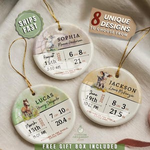 May include: Three personalized baby birth announcement ornaments. Each round ornament features a baby animal illustration, baby's name, birth date, time, weight in pounds and ounces, and length in inches. The ornaments have gold hanging strings.