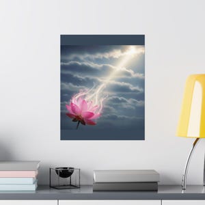 May include: A rectangular wall art print featuring a vibrant pink lotus flower emitting a glowing white light upward into a dark, cloudy sky. The scene captures a dramatic contrast between the bright, ethereal bloom and the deep, stormy atmosphere.