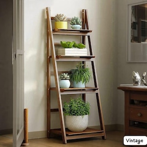 May include: A wooden ladder-style plant stand with four shelves, displaying various potted plants. The stand is made of dark brown wood and leans against a wall. The plants include succulents and leafy green plants in various pots.