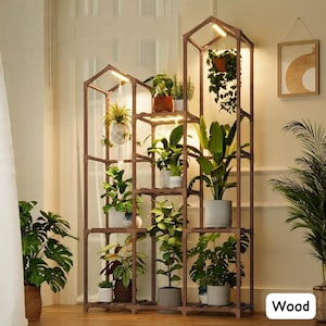 May include: A wooden plant stand with multiple shelves and built-in lighting. The stand is filled with various potted plants, creating a natural and decorative display. The word "Wood" is visible in the bottom right corner.