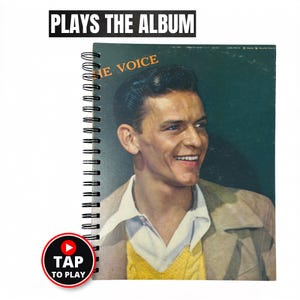May include: A spiral-bound notebook featuring a portrait of Frank Sinatra on the cover with the text THE VOICE. Above the notebook, the text PLAYS THE ALBUM is visible. A circular icon with a play button and the text TAP TO PLAY is present.