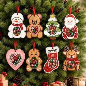May include: Eight hanging Christmas ornaments in various shapes including a snowman, teddy bear, tree, Santa, heart, gingerbread person, stocking, and reindeer. Each ornament features a clear circular window filled with small, colourful metallic spheres.