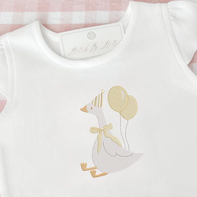May include: White onesie with a whimsical embroidered goose wearing a party hat and bow tie, holding two balloons. The goose is in shades of gold and tan. The onesie has short sleeves and a tag that reads "Match By Style".
