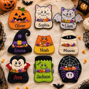 May include: Nine embroidered Halloween-themed felt ornaments featuring characters including a pumpkin, cat, bat, witch hat, candy corn, mummy, vampire, Frankenstein's monster, and spider. Each ornament displays a name: Oliver, Sophia, Liam, Emma, Noah, Mason, Ava, Jackson.