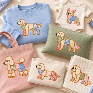 May include: A collection of items featuring embroidered dog designs: a light blue sweatshirt, a cream baby bodysuit, a sage green rectangular pillow, a pink canvas tote bag, a cream zippered pouch, and a cream waffle-textured towel.
