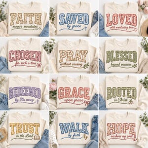 May include: A collection of twelve cream-colored crewneck sweatshirts, each featuring a large collegiate-style word in a patterned fabric fill, accompanied by a smaller script phrase and a small graphic icon related to the text.