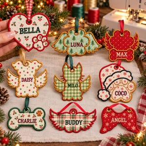 May include: A collection of nine embroidered felt Christmas ornaments in various shapes including hearts, bones, and wings. Each ornament features a name: Bella, Luna, Max, Daisy, Milo, Coco, Charlie, Buddy, and Angel, with festive patterns.