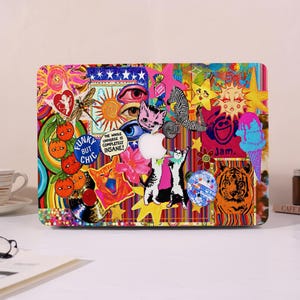 May include: A laptop cover featuring a vibrant collage of colorful stickers including a zebra, a tiger, cats, a dragonfly, an ice cream cone, suns, stars, and text that reads Funky But Chic and The Whole Universe Is Completely Insane.