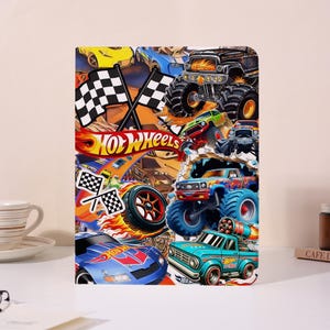 May include: A vibrant Hot Wheels-themed notebook showcasing race cars, monster trucks, and chequered flags. The design incorporates the Hot Wheels logo and dynamic illustrations of vehicles in action, with a lively, energetic composition.