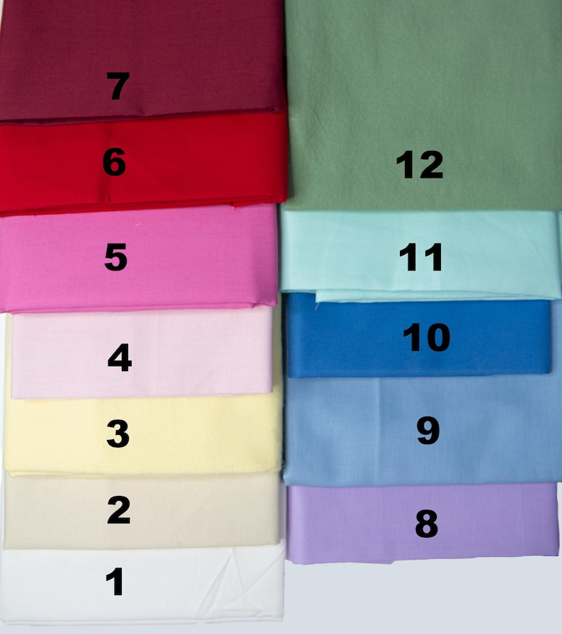 May include: A collection of folded fabric swatches in various colors, including white, cream, yellow, pink, red, blue, and green. Each swatch is labeled with a number from 1 to 12, providing a visual guide to the color options.