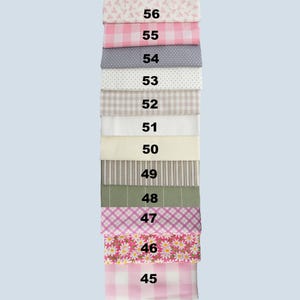 May include: A stack of fabric swatches in various patterns and colors. The swatches include gingham, polka dots, stripes, and floral designs. Each swatch is labeled with a number from 45 to 56.