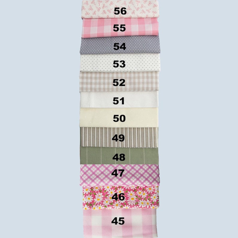 May include: A stack of fabric swatches in various patterns and colors. The swatches include gingham, polka dots, stripes, and floral designs. Each swatch is labeled with a number from 45 to 56.