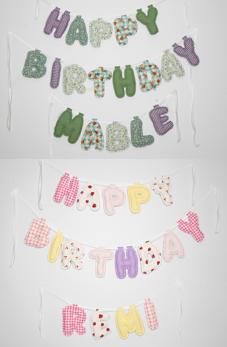 May include: Fabric banners with the words "HAPPY BIRTHDAY MABLE" and "HAPPY BIRTHDAY REMI" in various colors and patterns. The letters are made of soft fabric and strung on white ribbons, perfect for a birthday celebration.