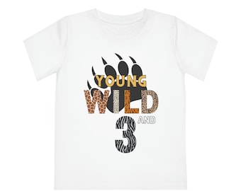May include: White t-shirt with a black bear paw print and the text "YOUNG WILD AND 3" in gold letters with animal print patterns.