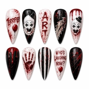 May include: A set of ten stiletto-shaped press-on nails featuring horror-themed designs. The nails display blood splatters, the clown character Art, a red balloon, a serrated blade, black and white stripes, and the text Terrifier and Who's Laughing Now?