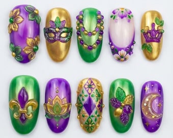 May include: A collection of ten artificial nails with a Mardi Gras theme. The nails feature designs in gold, green, and purple, including floral patterns, a mask, a crown, and a fleur-de-lis. The nails are oval-shaped and have a glossy finish.
