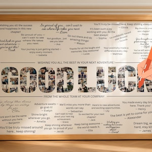 May include: A framed print with the words "GOOD LUCK" composed of photos. The print includes well wishes and messages from a team, with a hand holding a pen in the corner. The frame is a light brown color.