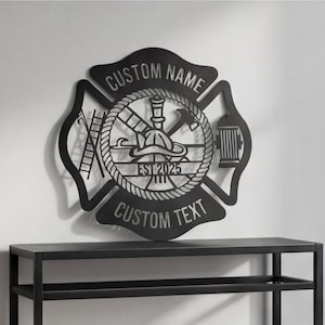 May include: A black metal wall sign shaped like a Maltese cross featuring a firefighter helmet, ladder, axe, and hydrant icon. The text CUSTOM NAME is at the top, EST 2025 in the center, and CUSTOM TEXT at the bottom, all enclosed by a rope border.
