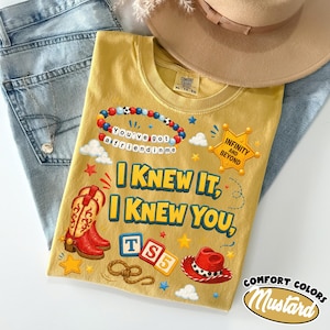 May include: A mustard yellow t-shirt featuring a graphic print with red cowboy boots, a red cowboy hat, a beaded bracelet with the text You've got a friend in me, a sheriff badge with Infinity and Beyond, and the text I KNEW IT, I KNEW YOU, TS5.