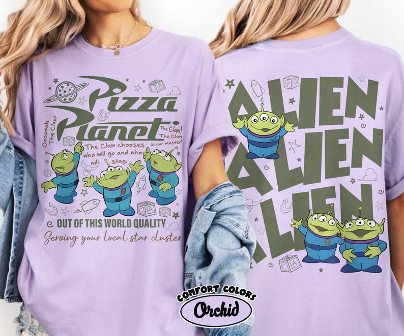 May include: A light purple t-shirt featuring the Pizza Planet logo and three green aliens in blue uniforms. The text reads "Out of this world quality" and "Serving your local star cluster."
