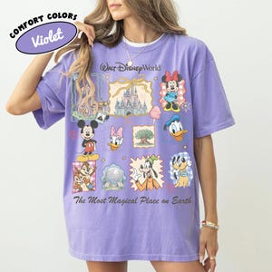 May include: Violet Comfort Colors t-shirt featuring Disney characters and the text "Walt Disney World" and "The Most Magical Place on Earth." The shirt has a crew neck and short sleeves. The graphic includes Mickey Mouse, Minnie Mouse, Donald Duck, and other characters.