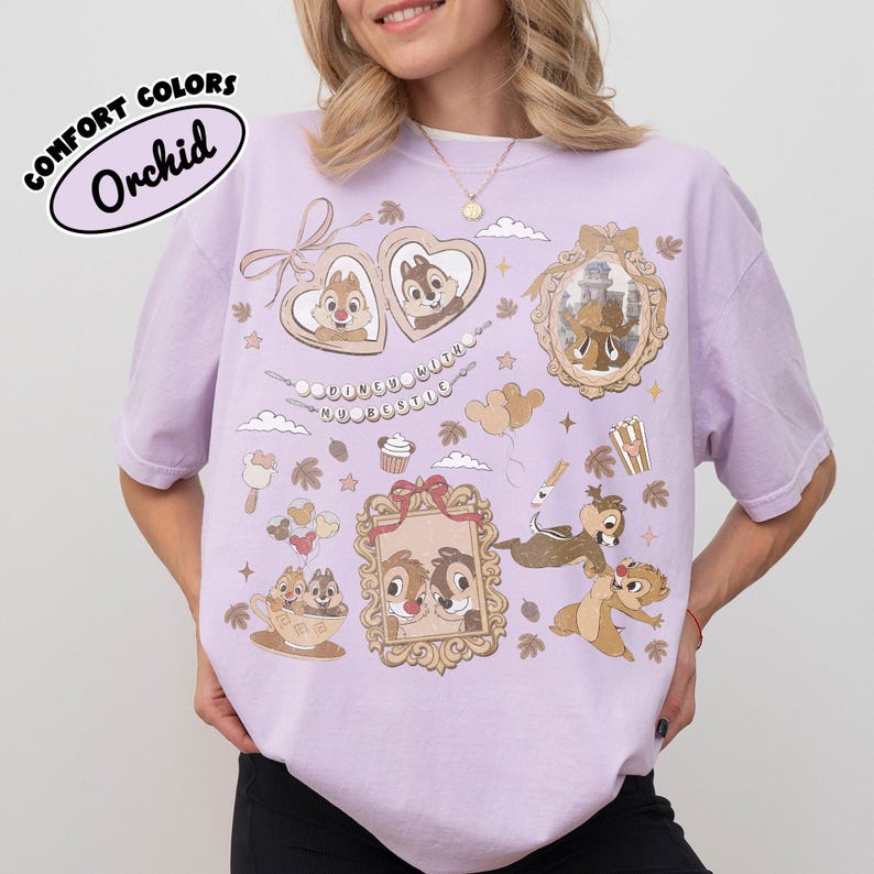 May include: Orchid-colored t-shirt with cartoon graphics of Chip and Dale, framed portraits, and food icons. The shirt features the text "COMFORT COLORS" and "Orchid" in a circular design. The design includes hearts, clouds, and stars.