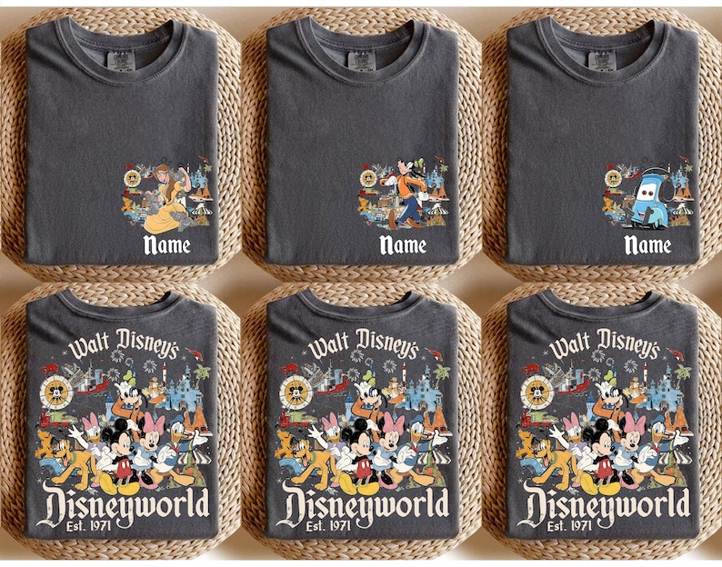 May include: Six charcoal gray t-shirts with Disney character graphics. Three shirts have a character graphic with the word "Name" below. The other three shirts have a Disneyworld graphic with "Est. 1971".