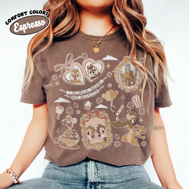 May include: Espresso-colored t-shirt featuring a collage of cartoon images in frames, hearts, and other shapes. The shirt has the words "Comfort Colors" and "Espresso" in a circular design at the top left.