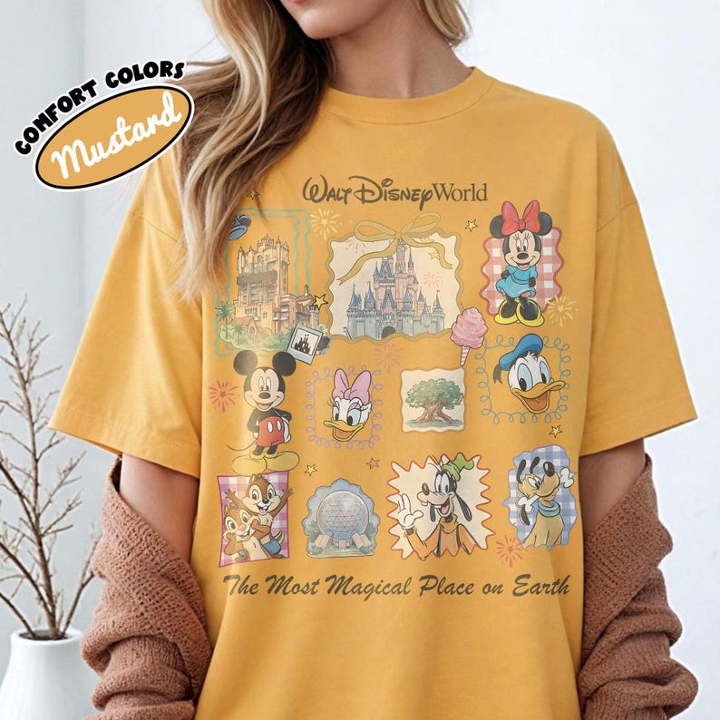 May include: Mustard-colored t-shirt with a Walt Disney World graphic. The design includes illustrations of Mickey Mouse, Minnie Mouse, Donald Duck, and other Disney characters. Text on the shirt reads "The Most Magical Place on Earth."