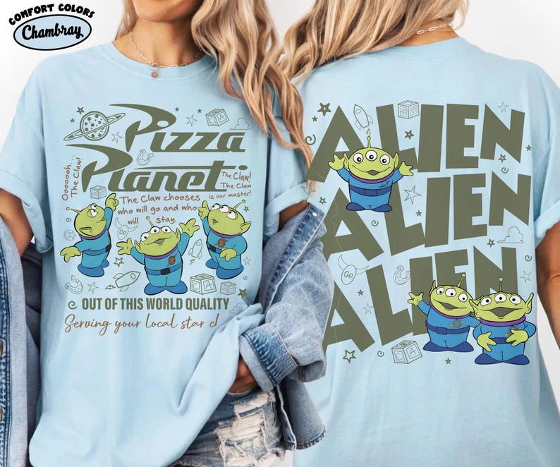 May include: Light blue t-shirt featuring a Pizza Planet design with three-eyed green aliens. The front of the shirt has the text "Pizza Planet" and "Out of this world quality". The back of the shirt has the word "ALIEN" repeated.
