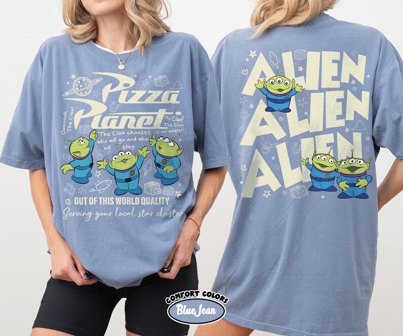 May include: Blue t-shirts with a Pizza Planet graphic on the front and Alien graphics on the back. The front design includes the text "Pizza Planet" and the phrase "Out of this world quality". The back features the word "Alien" repeated.