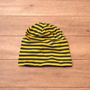 Vintage style striped beanie hat in yellow and black.