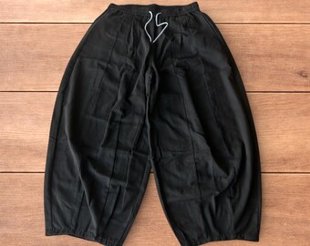 Baggy wide leg parachute trousers in black.