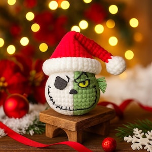 May include: A handmade crochet Christmas ornament featuring a split design: half Jack Skellington and half the Grinch, wearing a red Santa hat. The ornament is placed on a small wooden stand, with a festive background of lights and decorations.