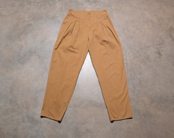 May include: A pair of tan pleated trousers with a high waist.