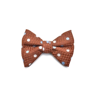 May include: A brown bow tie with a woven texture and a pattern of white and light blue polka dots. A classic accessory for formal occasions.