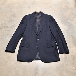 May include: A dark blue pinstripe blazer with a single-breasted closure and two button pockets.