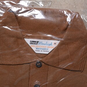 May include: A brown polo shirt with a white label that reads "Grants Pennleigh 100% Textured Nylon Washable Made in Taiwan" and a size "M".