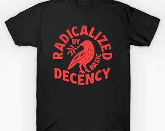 May include: Black t-shirt with a red graphic. The graphic features a bird holding a sprig and the words "RADICALIZED BY BASIC DECENCY" in a circular design. The shirt is a crew neck style.