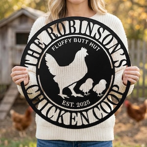 May include: Black metal circular sign with the text "THE ROBINSON'S CHICKEN COOP" and the words "FLUFFY BUTT HUT" above a hen and two chicks. The sign also includes the text "EST. 2025".
