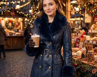 May include: A navy blue double-breasted coat featuring a dark faux fur collar and matching fur cuffs. The coat includes a belted waist with a gold-toned buckle, gold buttons, and two front flap pockets, worn with brown leather gloves.