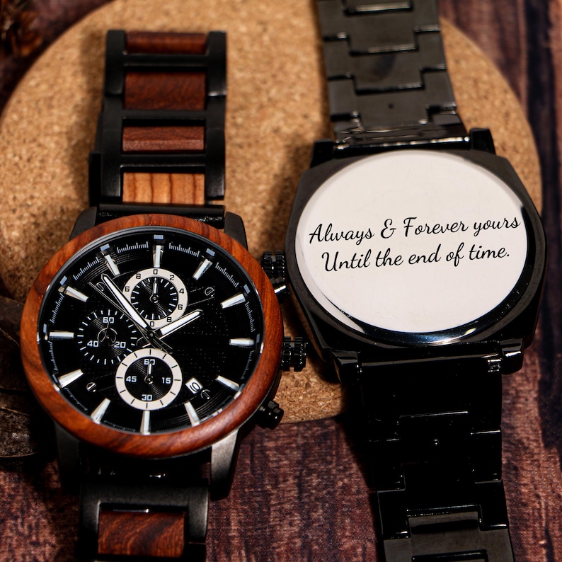 May include: Two black wristwatches with wooden and black metal accents. One watch has a black face with white details and a wooden bezel. The other watch has the inscription "Always & Forever yours Until the end of time."