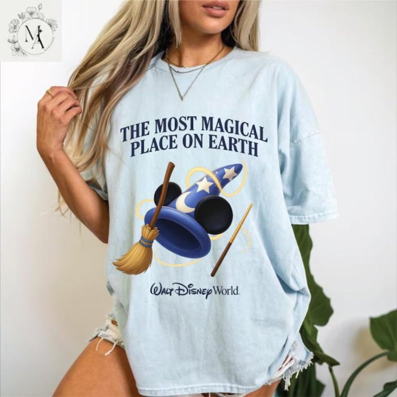 A woman wearing a light blue t-shirt with a graphic design of a wizard hat and wand, along with the text "The most magical place on earth" and "Walt Disney World".