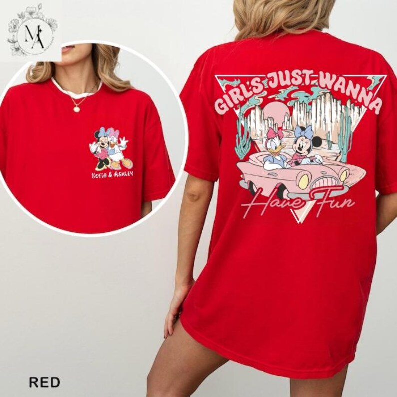 A red t-shirt with a cartoon image of Minnie Mouse and Donald Duck, along with the text "Girls Just Wanna Have Fun" printed on the back.