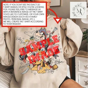 a person wearing a white t-shirt with a cartoon character design, specifically a group of Disney characters.